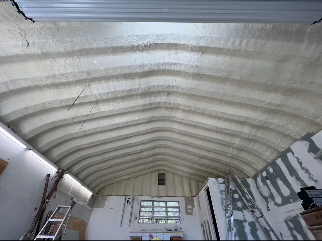 Spray polyurethane foam applied to the underside of a metal roof deck in Mason